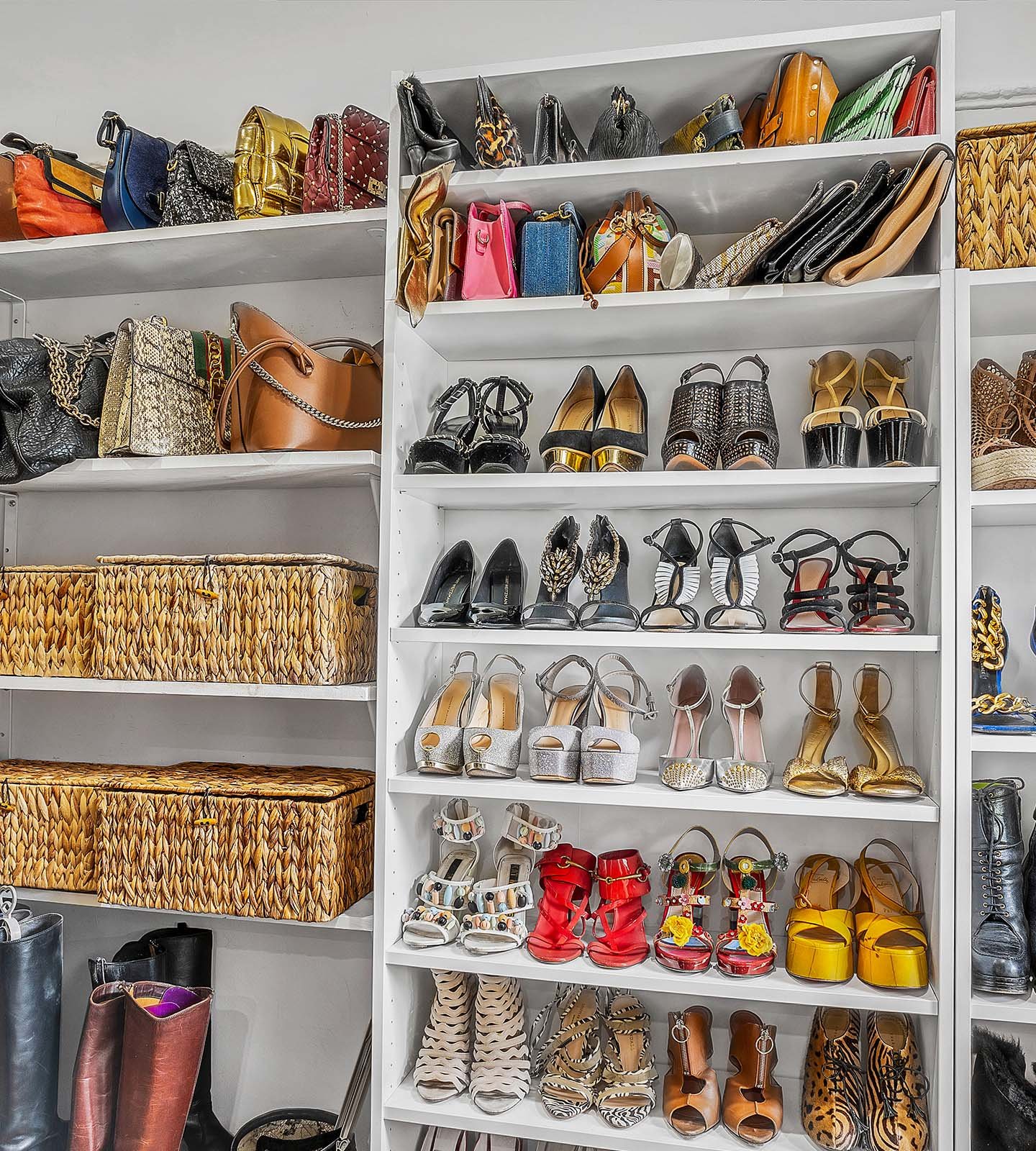 Handbags and shoes arranged on white closet shelving